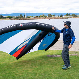 An instructor showing the basics of wingfoiling with a sail An instructor showing the basics of wingfoiling with a sail