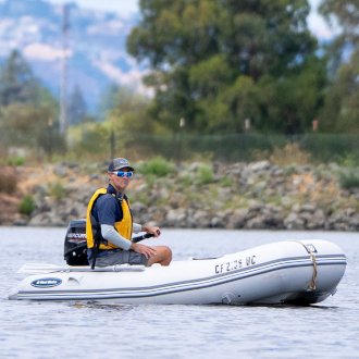 Sailing instructor driving a powerboat.
